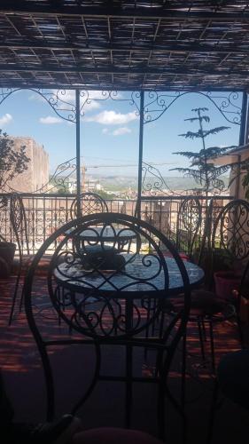 a table and chairs in front of a window at Esc 9 in Fez