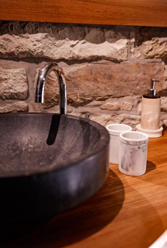 a sink with a faucet on top of a counter at Le Pays des Sources in Waimes
