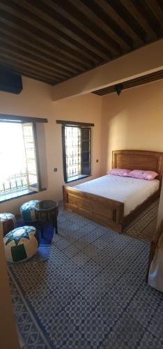 a bedroom with a large bed and a table at Esc 9 in Fez