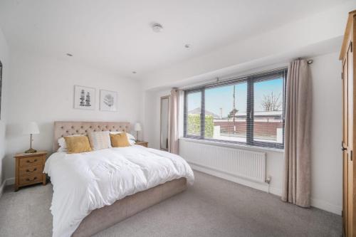 a bedroom with a bed and a large window at Large modern self contained apartment in Lymington in Lymington