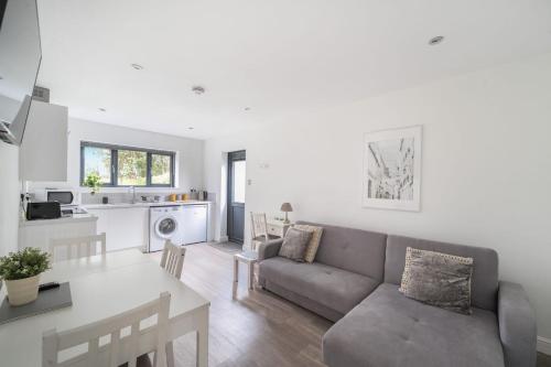 a living room with a couch and a table at Large modern self contained apartment in Lymington in Lymington