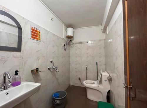 a bathroom with a white toilet and a sink at The Boho Darjeeling in Darjeeling