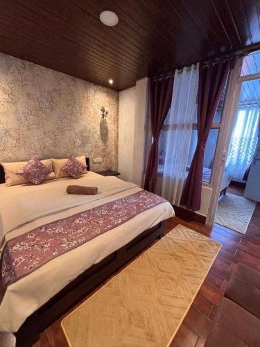 a bedroom with a large bed and a window at The Boho Darjeeling in Darjeeling