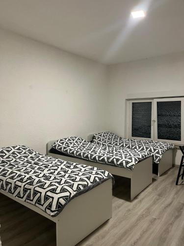 a room with two beds and a table in it at Monteurswohnung Hamm in Hamm
