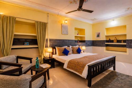a bedroom with a large bed and a couch at Kalyan Villa Heritage Stay in Udaipur