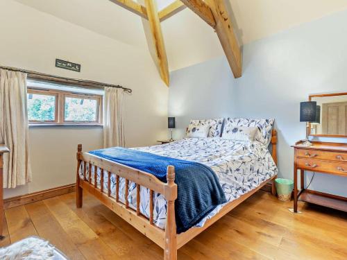 a bedroom with a bed and a wooden floor at 3 Bed in Winkleigh oc-1450b in Iddesleigh