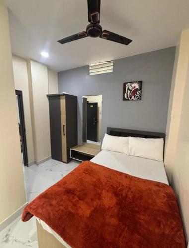 a bedroom with a bed and a ceiling fan at Hotel Magic Inn in Nagpur