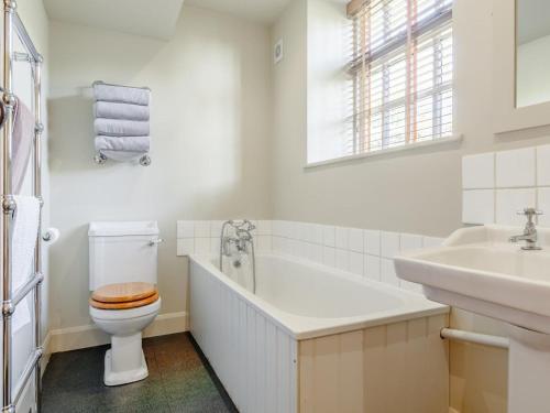 a white bathroom with a toilet and a sink at 2 Bed in Axminster oc-blolo in Axminster