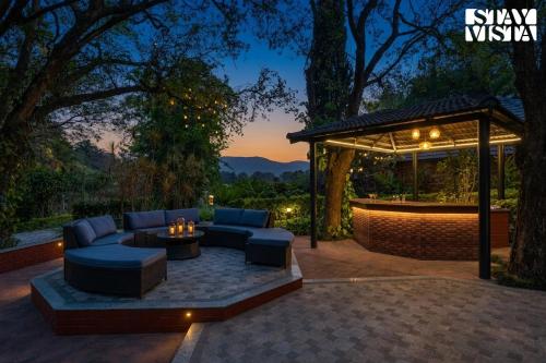 a patio with a couch and a gazebo at StayVista at Ananta - Breakfast Included & Basketball Court in Bangalore