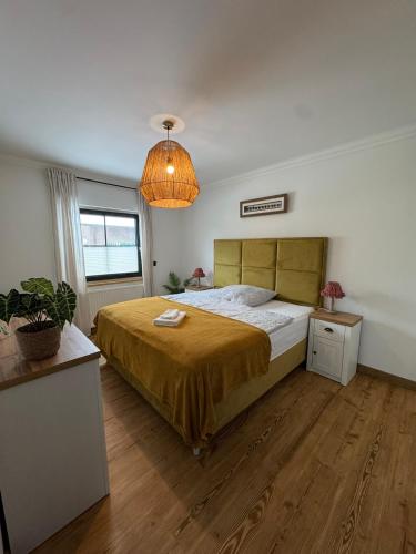 a bedroom with a bed and a pendant light at Haus Schönsee - 2 Apartments, ideal für Familien & Freunde in Heede
