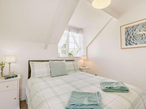 a bedroom with a bed with two towels on it at 2 Bed in Bideford oc-60428 in Westward Ho