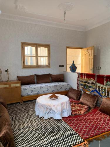 a living room with a couch and a table at Chez houssam in Ouarzazate