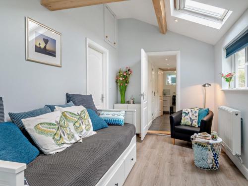 a living room with a couch and a chair at 1 Bed in Bridport oc-94617 in Chideock