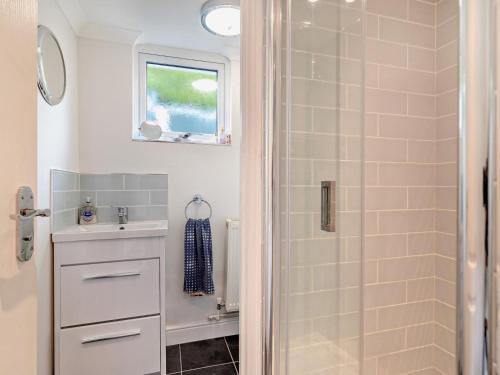 a bathroom with a shower and a sink at 1 Bed in Bridport oc-94617 in Chideock