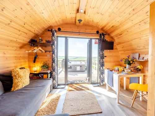 a room with a large couch in a wooden house at 1 Bed in Barnstaple oc-90190 in Bratton Fleming