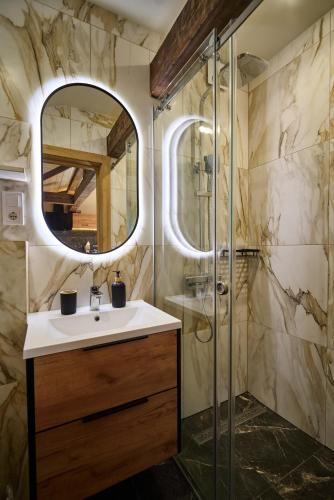 a bathroom with a sink and a shower at Guest House Plai in Yaremche