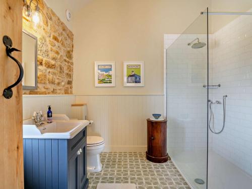 a bathroom with a toilet and a sink and a shower at 2 Bed in Stoke Abbott oc-94406 in Stoke Abbott