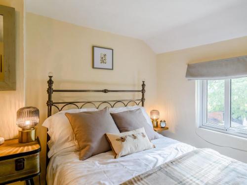 a bedroom with a bed and a window at 2 Bed in Crediton oc-79431 in Sandford
