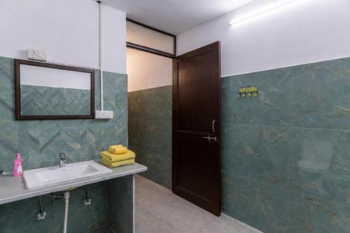 a bathroom with a sink and a mirror at Kalyan Villa Heritage Stay in Udaipur
