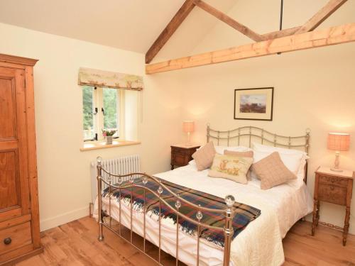 a bedroom with a bed and a wooden floor at 2 Bed in Stoke Abbott oc-50884 in Stoke Abbott