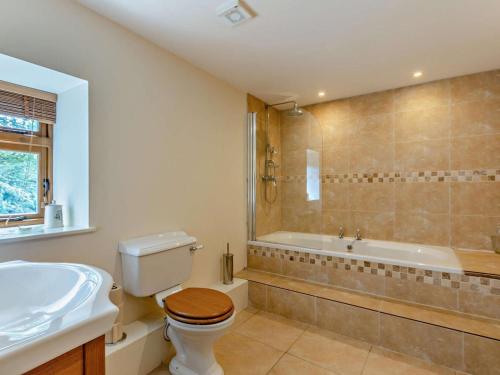 a bathroom with a toilet and a sink and a tub at 1 Bed in Tiverton oc-94766 in Bampton