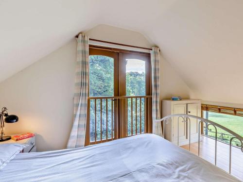 a bedroom with a bed and a large window at 1 Bed in Tiverton oc-94766 in Bampton