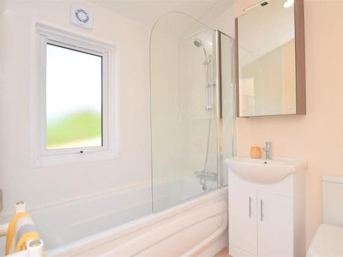 a white bathroom with a sink and a shower at 2 Bed in Honiton oc-76515 in Ottery Saint Mary