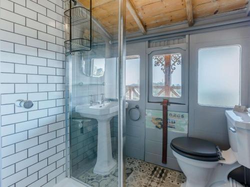 a bathroom with a toilet and a sink at 1 Bed in Exeter oc-75423 in Longdown