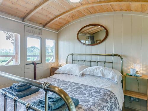 a bedroom with a bed and a mirror on the wall at 1 Bed in Exeter oc-75423 in Longdown
