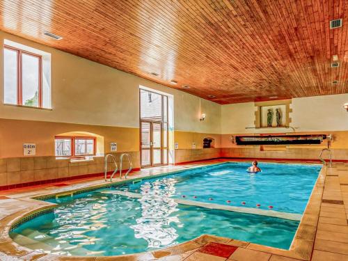 a swimming pool with a person in the water at 3 Bed in Taunton oc-96235 in West Quantoxhead