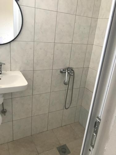 a bathroom with a shower and a sink at IN Villa Guesthouse in Sutomore