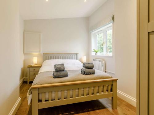 a bedroom with a bed with two pillows on it at 2 Bed in Taunton oc-83696 in Thorn Falcon