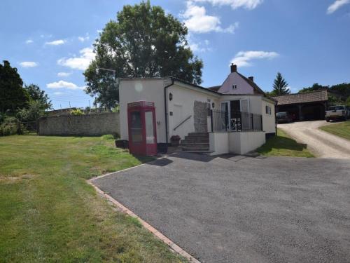 a white house with a red door in a yard at 2 Bed in Taunton oc-83696 in Thorn Falcon