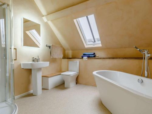 a bathroom with a toilet and a tub and a sink at 4 Bed in Minehead oc-90504 in Dunster