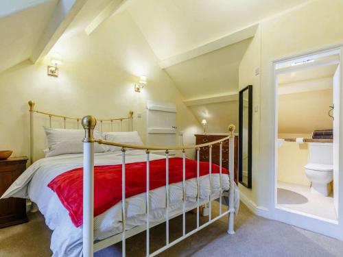 a bedroom with a bed with a red blanket at 4 Bed in Minehead oc-90504 in Dunster