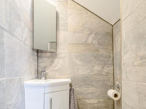 a bathroom with a white sink and a mirror at 1 Bed in Okehampton oc-78799 in Hatherleigh