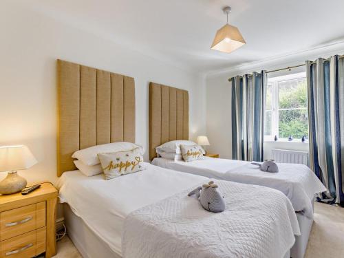 a bedroom with two beds and a window at 4 Bed in Bideford oc-nilga in Bideford