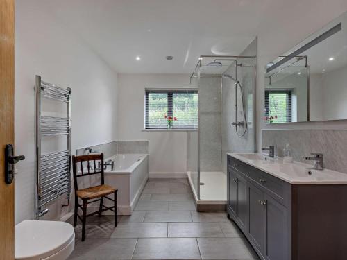 a bathroom with a tub and a toilet and a sink at 5 Bed in Dulverton oc-87003 in Morebath