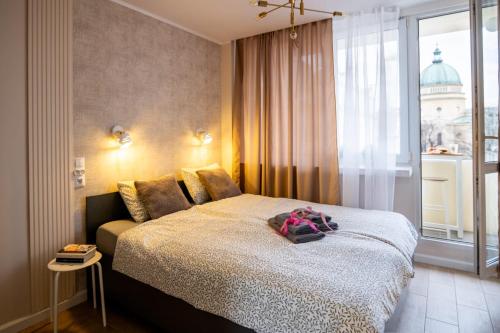 a bedroom with a bed and a window at Super Central Modern Flat with Balcony & View! #55''Smart TV #Fast Wi-Fi #Metro in Warsaw