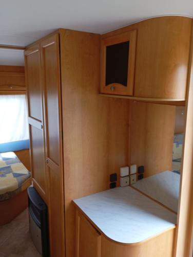 a small kitchen with a cabinet and a bed at CCA area in Hio