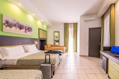 a hotel room with two beds and a television at Napoli Suite in Naples