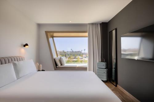 a bedroom with a white bed and a window at Hotel SB Win 4 Sup in Sant Feliu de Llobregat