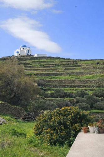 a house on top of a hill with a field at Dreamy View in Folegandros in Áno Meriá