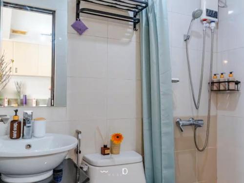 a bathroom with a shower and a toilet and a sink at Condo in Cubao, Sunset & City Lights Chasing in Manila