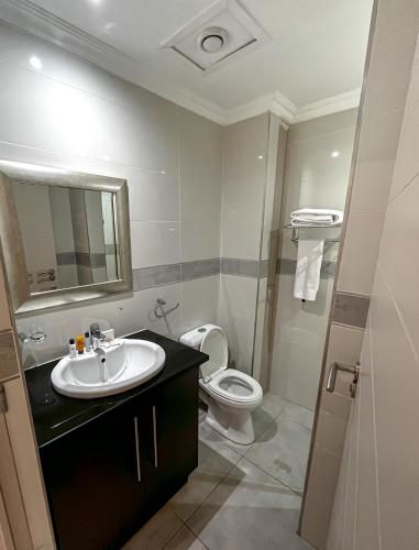 a bathroom with a sink and a toilet at Golden Crystal Hotel Gaborone in Gaborone