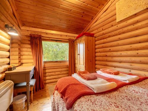 a bedroom with a bed in a log cabin at 2 Bed in Bideford oc-00370 in Clovelly