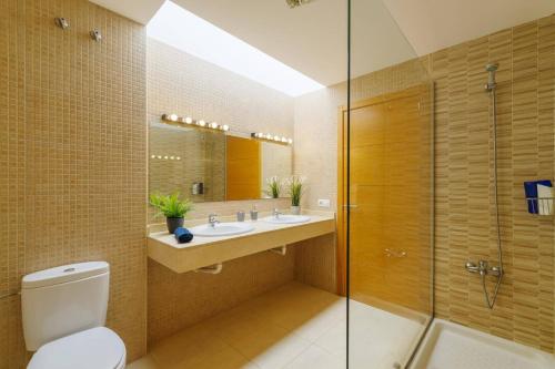 a bathroom with a toilet and a sink and a shower at Villa Sunshine Lanzarote by Villa Plus in Teguise