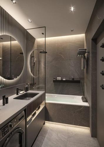 a bathroom with a tub and a sink and a bath tub at Amiron Hotel in Dushanbe