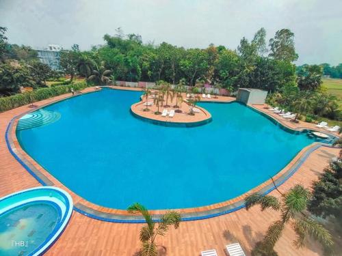 an overhead view of a large blue swimming pool at Fiona Luxury Resort in Gazipur