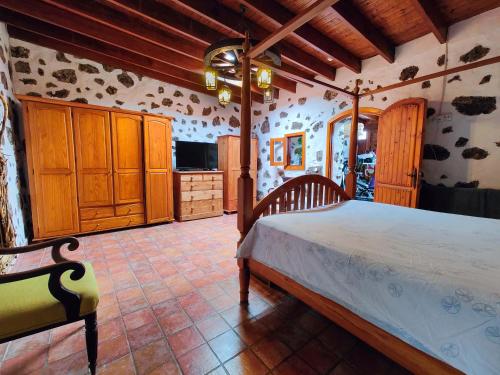 a bedroom with a large bed in a room at Casa Morro Herreno in Las Breñas